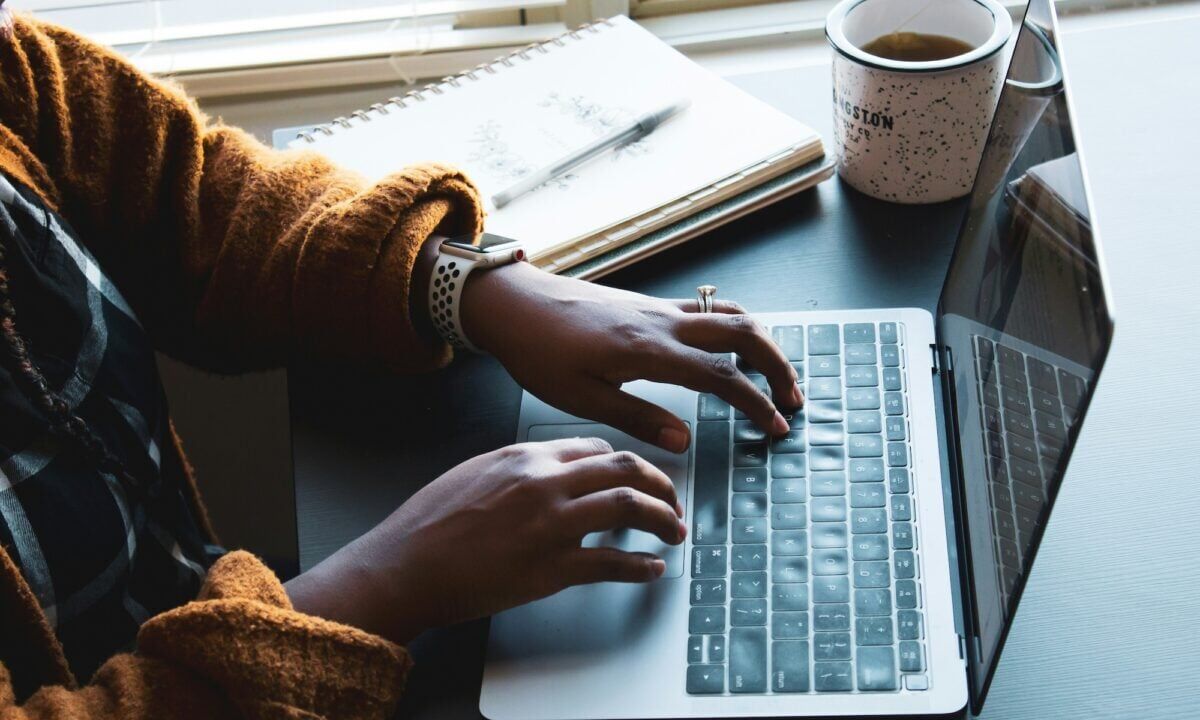 An agent sits in front of their laptop working on creating cost-effective real estate crm email campaigns