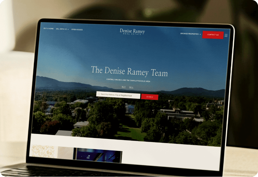 A laptop showing the home page of the Denise Ramey real estate team's website